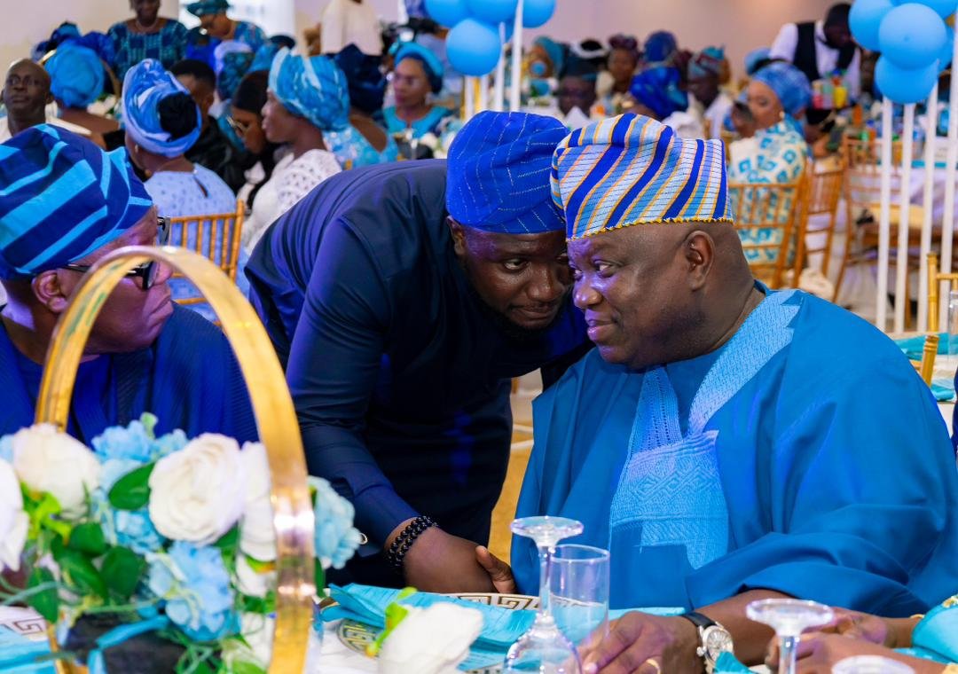 Abayomi engaging guests at a social event